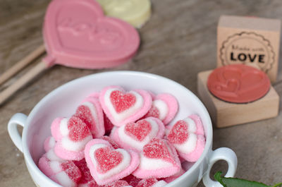 High angle view of heart shape on pink table