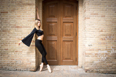 Full length of woman standing by door