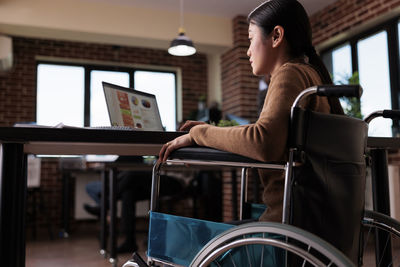 Young woman using laptop at table