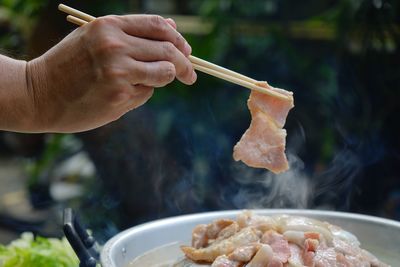 Thailand style bbq grill on a charcoal fire that is located on the bottom with pork, shrimp, squid 