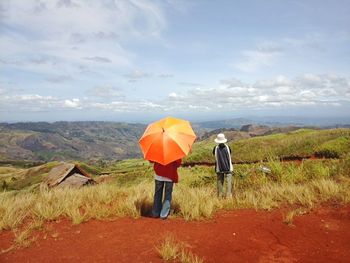 Scenic view of landscape against cloudy sky