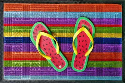Directly above shot of multi colored shoes on grass