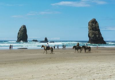People on beach against sky