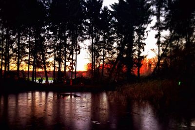 Scenic view of lake against sky at sunset