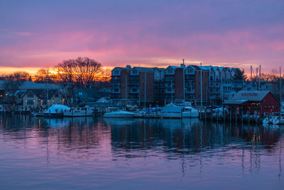 Reflection of buildings in lake at sunset