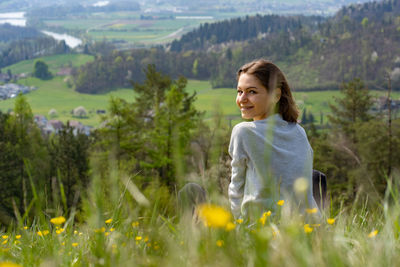 Portrait of woman standing on field