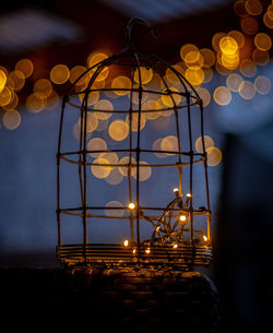 Illuminated lights hanging from ceiling at night