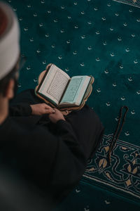 High angle view of man reading book