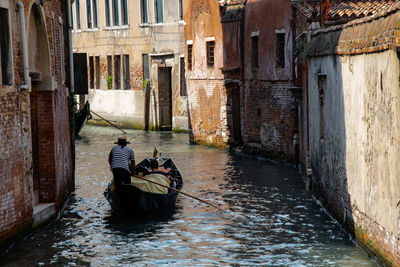 People sitting on boat in canal