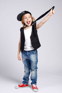 Portrait of smiling girl standing against white background