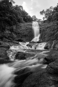 Scenic view of waterfall against sky