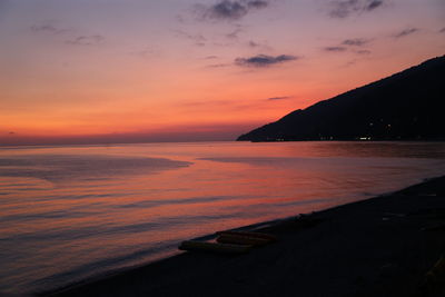 Scenic view of sea against romantic sky at sunset