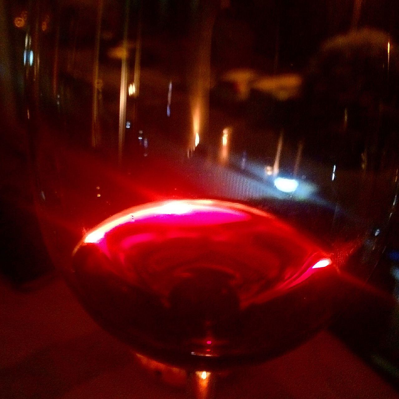 drink, illuminated, refreshment, food and drink, alcohol, close-up, wineglass, wine, red wine, red, night, focus on foreground, glowing, dark, nightlife, electric light, multi colored, freshness, wine glass