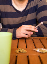 Midsection of woman using mobile phone