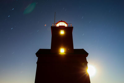 Low angle view of lighthouse against sky at night