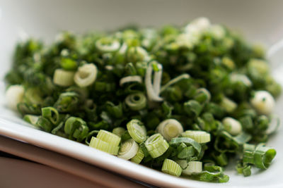 Close-up of chopped spring onions in plate