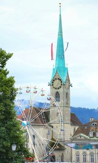 Ferris wheel in city against sky