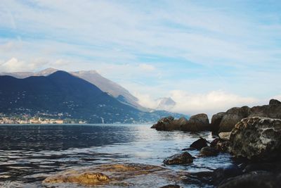 Scenic view of sea and mountains against sky