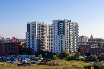 Buildings in city against clear sky