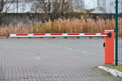 Parking gate, automatic car barrier system for car-park security. white red boom gate.