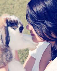 Close-up of woman with rabbit outdoors