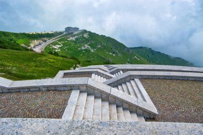 Built structure on landscape against sky