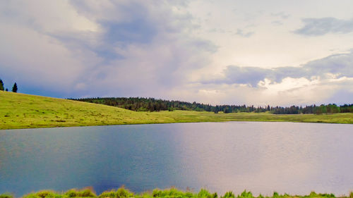 Scenic view of landscape against cloudy sky