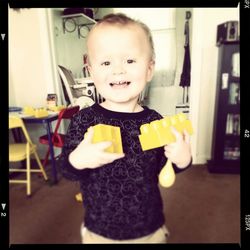 Portrait of cute boy holding toy