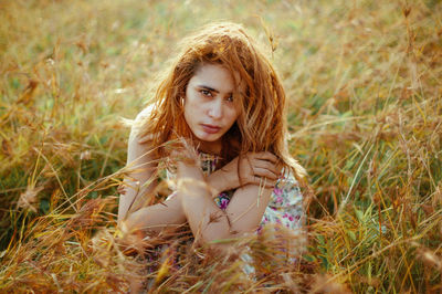 Portrait of a girl sitting on field