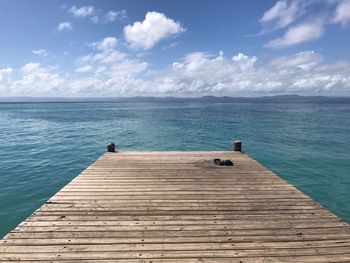 Pier over sea against sky