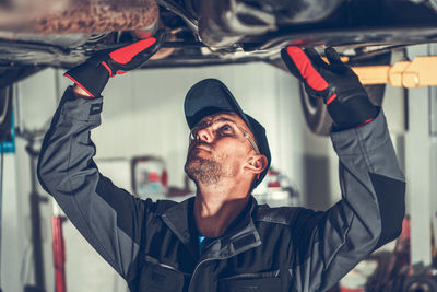 Mechanic repairing car at garage