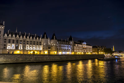 The conciergerie and the seine river illuminated at night
