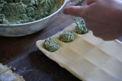 Midsection of person preparing food on table