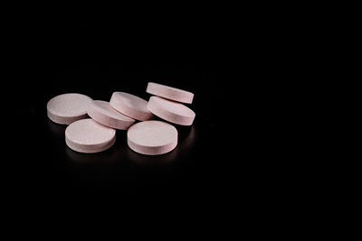 Close-up of pills against black background
