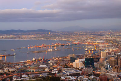 High angle view of buildings by sea against sky