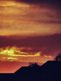 Silhouette of landscape against cloudy sky