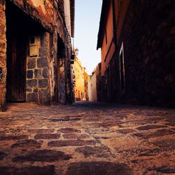 Empty alley amidst buildings in city