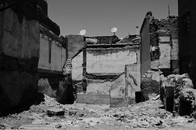 Old building by street against sky