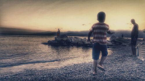 Rear view of man standing on beach