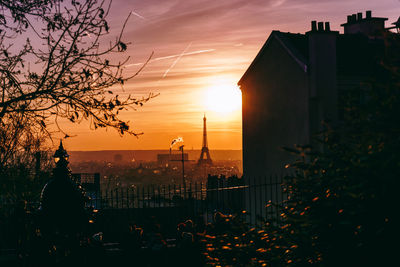 Scenic view of city against sky during sunset