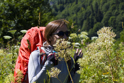 Hiker and backpacker in the mountain valley and field, trekking and hiking scene in svaneti