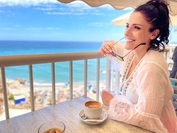 Smiling woman sitting at cafe