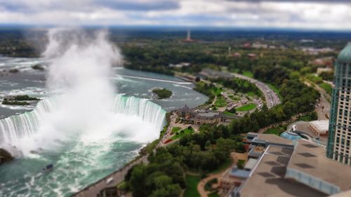 Aerial view of river amidst trees against sky