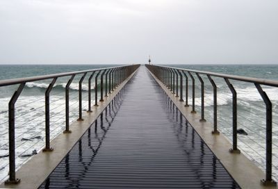 Pier over sea against clear sky