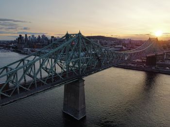 Bridge over river at sunset