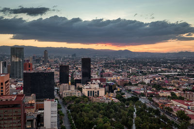 High angle view of buildings in city against sky during sunset