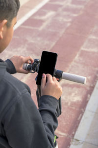 Young man on an electric skate using smartphone gps application