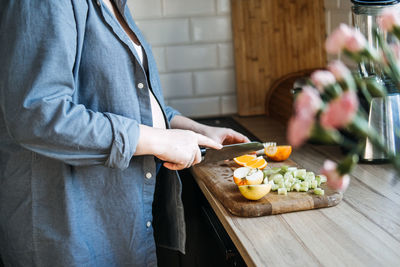 Midsection of man preparing food on table