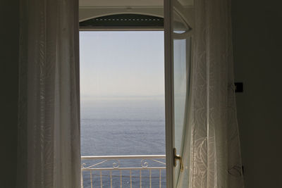 View of sea seen through window