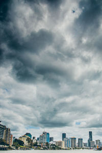 High section of cityscape against cloudy sky